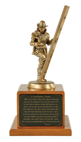 Bronze firefighter on a ladder rescuing a child; mounted on a solid walnut base. Firefighter’s Prayer may be engraved on brass plate. 