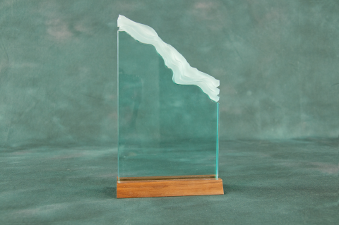 Attractive White Cap edge accents clear or jade acrylic piece on walnut base.