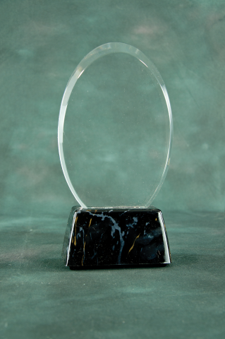  Oval shaped acrylic mounted on a black marble finished base.